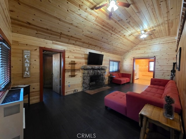 living area featuring vaulted ceiling, wooden walls, a ceiling fan, wood ceiling, and hardwood / wood-style flooring