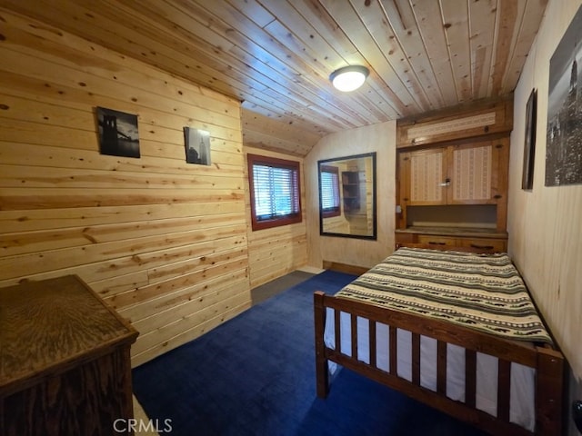 bedroom with wood walls, dark colored carpet, wood ceiling, and vaulted ceiling