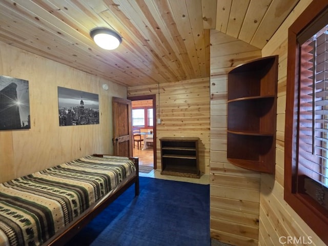 bedroom with wooden walls and wood ceiling