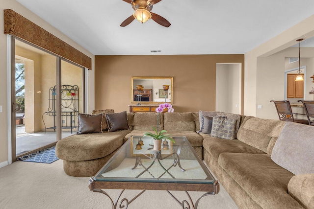 carpeted living room featuring ceiling fan