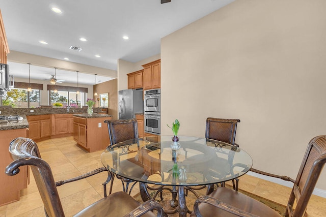 dining space featuring ceiling fan