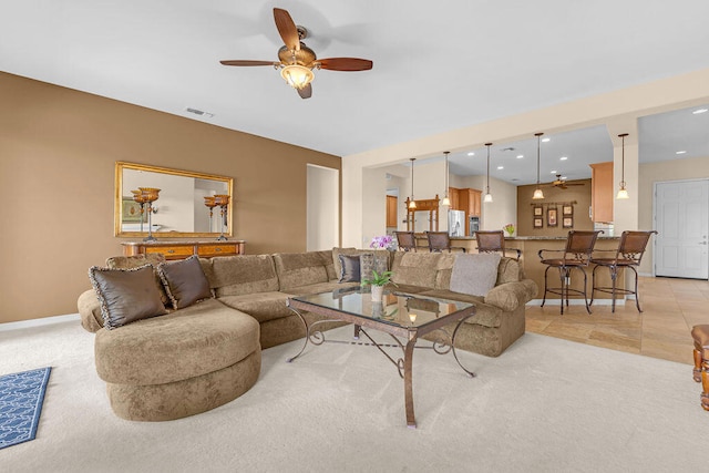 living room featuring ceiling fan and light colored carpet