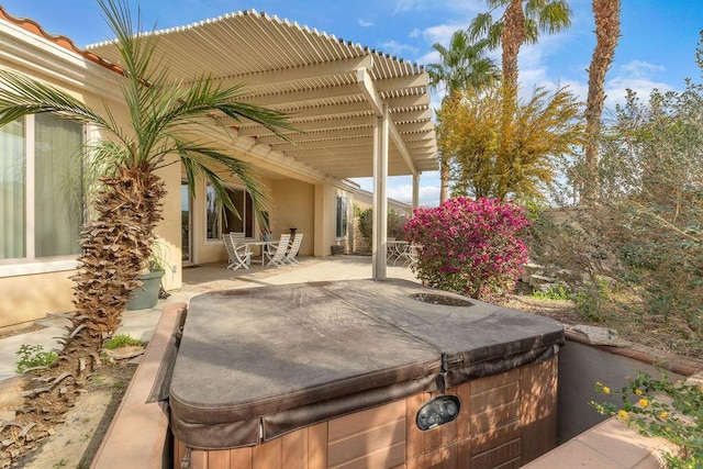 view of patio with a hot tub and a pergola