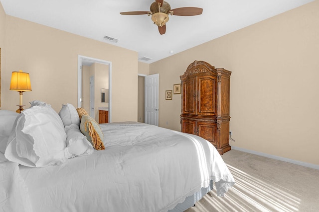 bedroom with ensuite bath, ceiling fan, and carpet