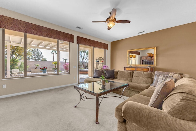 carpeted living room featuring ceiling fan