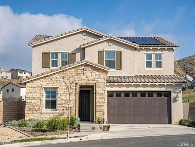 24583 Acadia Dr, Corona, CA 92883 - view of front of property featuring stone siding, driveway, roof mounted solar panels, a garage, and stucco siding