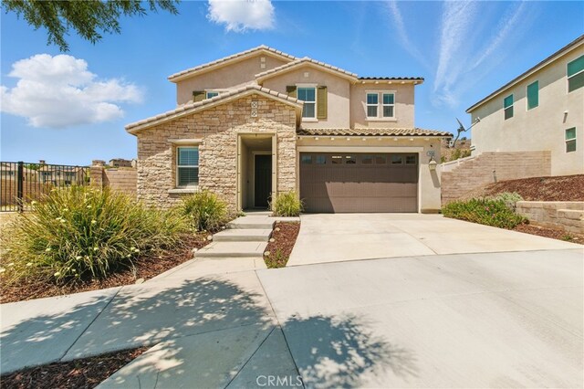 24583 Acadia Dr, Corona, CA 92883 - view of front of house with stucco siding, stone siding, a tiled roof, concrete driveway, and a garage