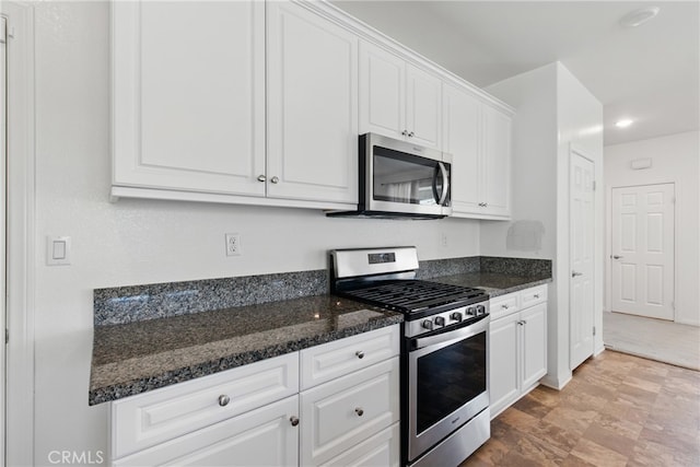 24583 Acadia Dr, Corona, CA 92883 - kitchen featuring appliances with stainless steel finishes, white cabinets, and dark stone counters