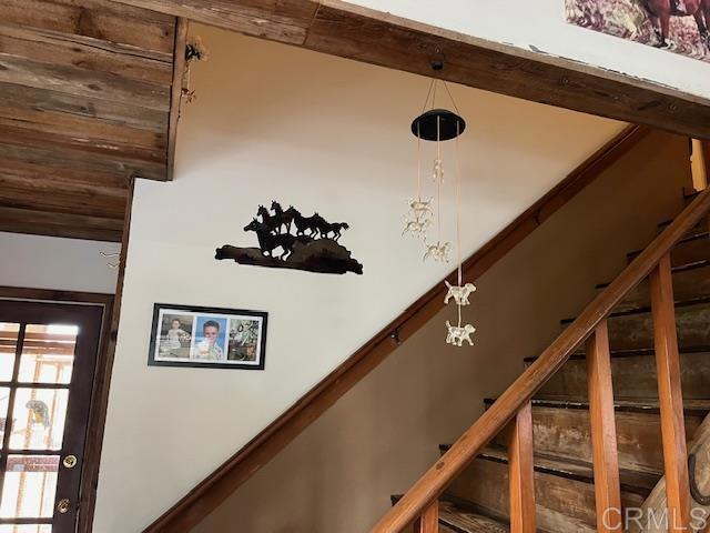 interior details featuring beamed ceiling and an inviting chandelier