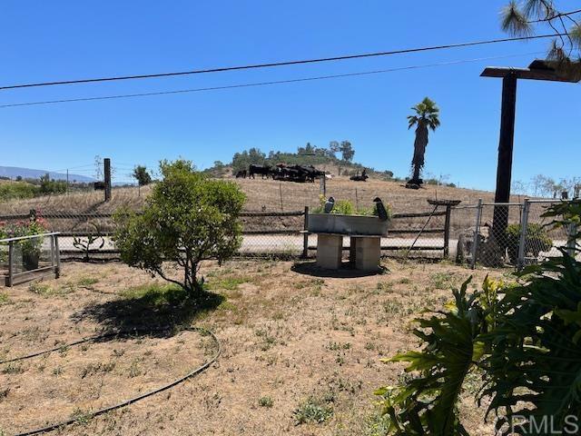 view of yard with a rural view