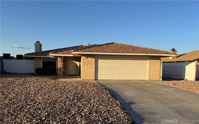 14376 Rivers Edge Rd, Helendale, CA 92342 - ranch-style house featuring driveway, a chimney, a garage, fence, and stucco siding