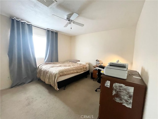 carpeted bedroom with visible vents and ceiling fan