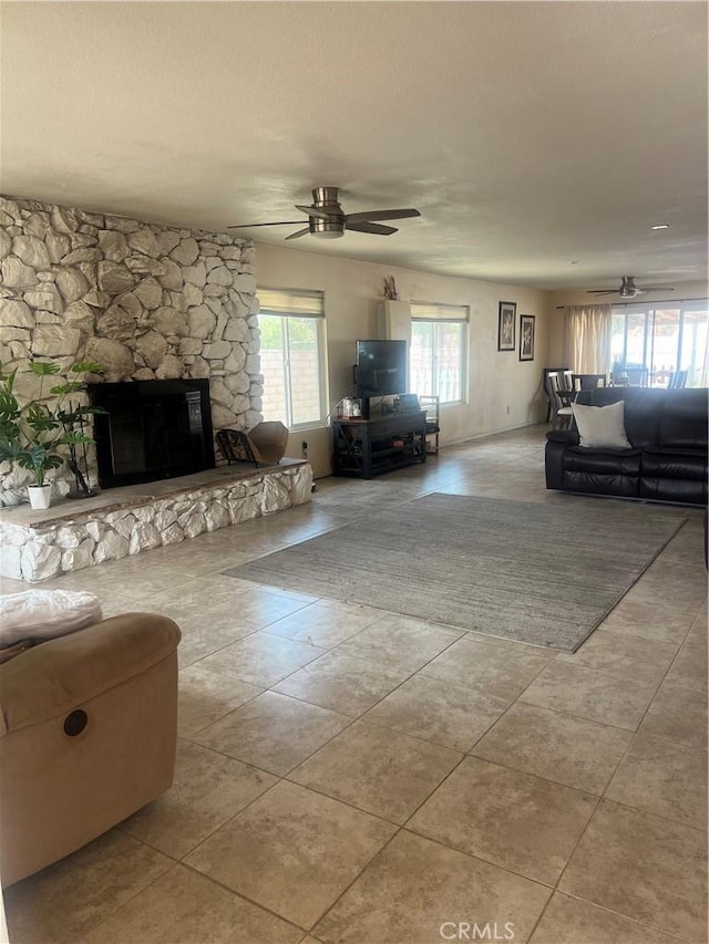 14376 Rivers Edge Rd, Helendale, CA 92342 - living room featuring tile patterned floors, ceiling fan, and a fireplace