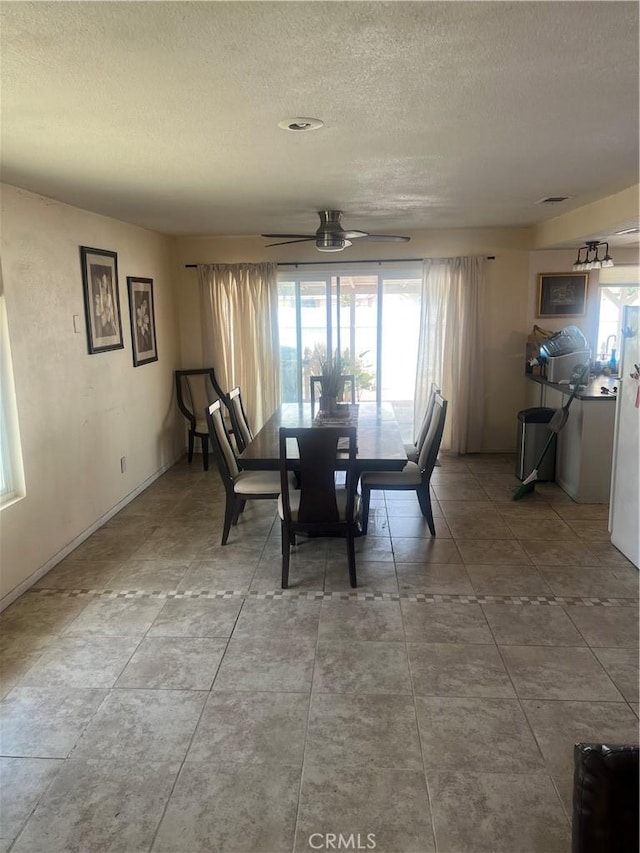 14376 Rivers Edge Rd, Helendale, CA 92342 - dining area featuring baseboards, a textured ceiling, and ceiling fan