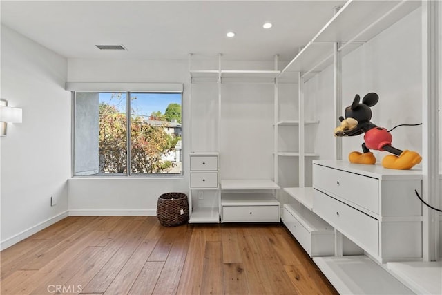 spacious closet with light hardwood / wood-style flooring