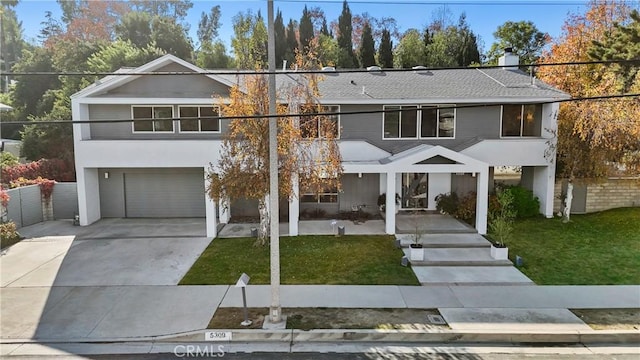 view of front facade with a garage and a front lawn