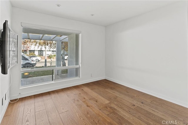 spare room with light hardwood / wood-style floors