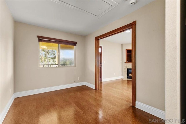 unfurnished room with a fireplace