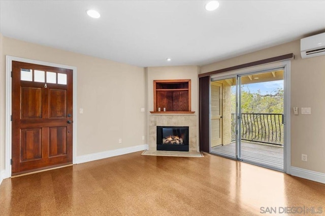 unfurnished living room featuring a fireplace and an AC wall unit