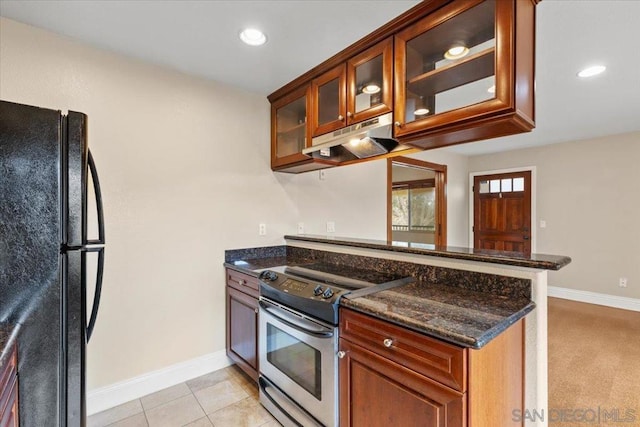 kitchen with black refrigerator, dark stone counters, light tile patterned floors, kitchen peninsula, and electric stove