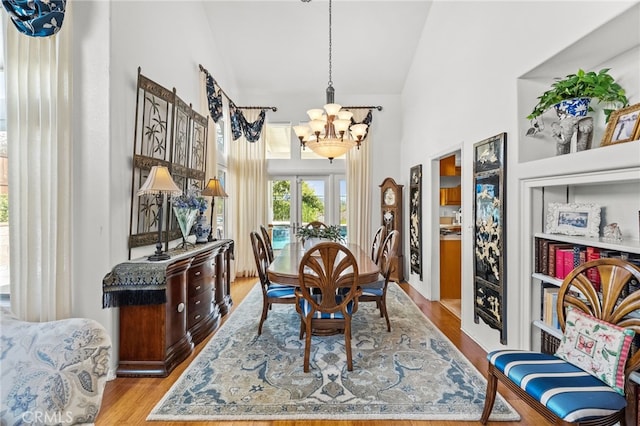 dining space featuring a chandelier and light wood-type flooring