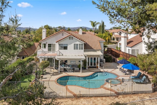 view of pool with outdoor lounge area, a pergola, a patio, and a mountain view