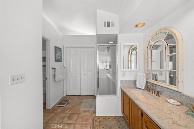 bathroom with vanity, tile patterned floors, a shower with door, and toilet