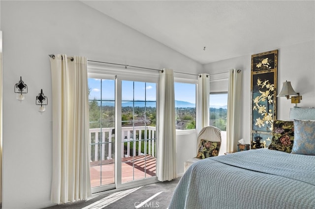 bedroom featuring vaulted ceiling, carpet, and access to outside