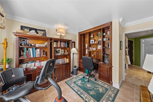 office area with light tile patterned flooring, crown molding, and built in desk