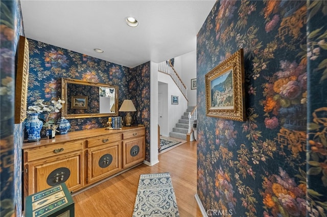 corridor with light hardwood / wood-style floors