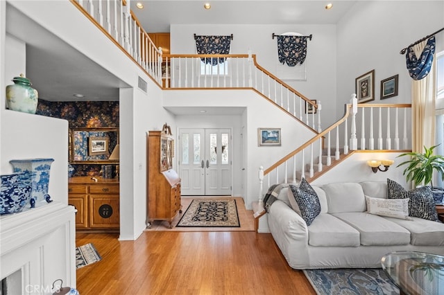 entryway featuring light hardwood / wood-style flooring and a high ceiling