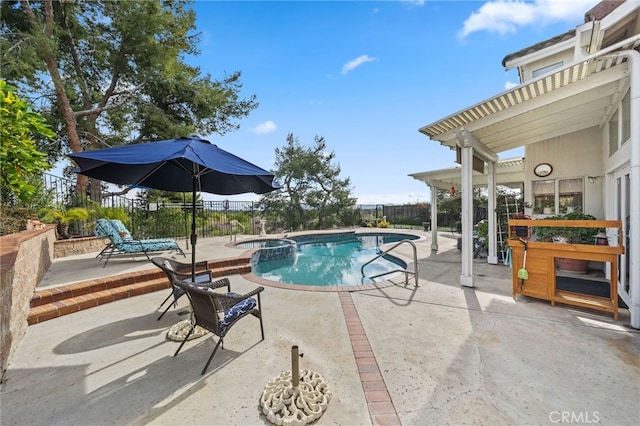 view of pool featuring a patio and an in ground hot tub