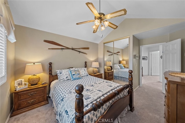 carpeted bedroom with lofted ceiling, a closet, and ceiling fan