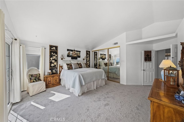 bedroom featuring vaulted ceiling, light colored carpet, and a closet