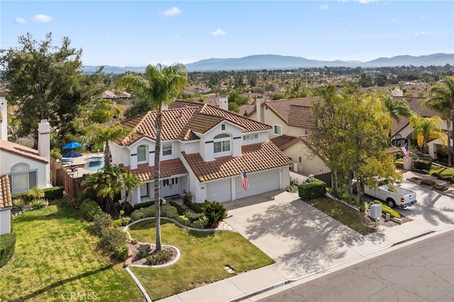 birds eye view of property with a mountain view