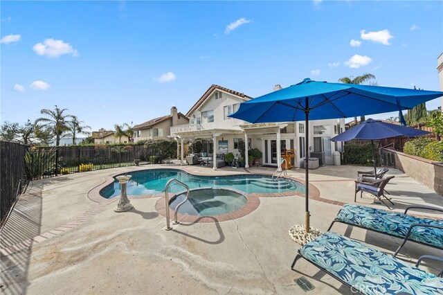 view of swimming pool with a pergola, a patio area, and an in ground hot tub