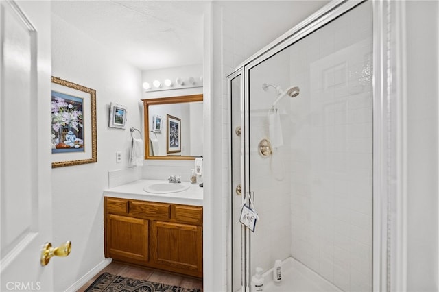 bathroom featuring vanity and a shower with shower door