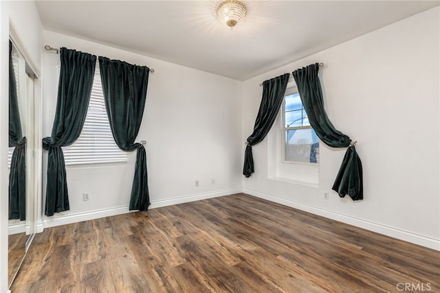 empty room with hardwood / wood-style flooring