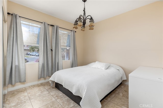 tiled bedroom with a chandelier