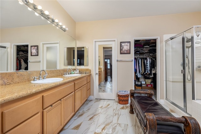 bathroom featuring vanity and an enclosed shower