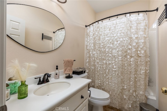 bathroom with vanity, curtained shower, and toilet