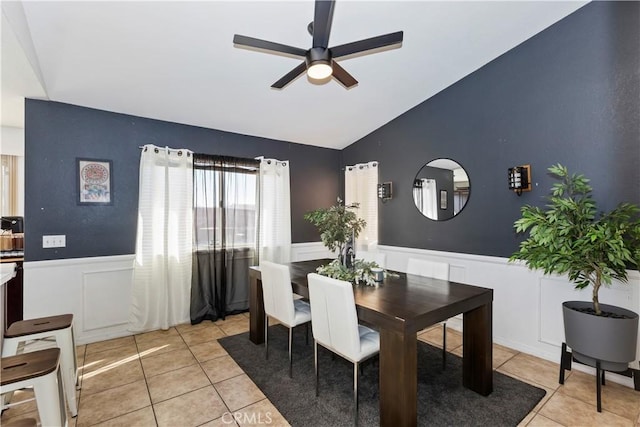 dining space with lofted ceiling, light tile patterned floors, and ceiling fan