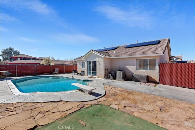 view of pool featuring a diving board, central AC, and a patio area