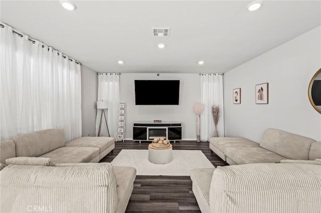 living room with dark hardwood / wood-style flooring