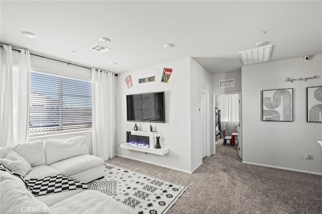 living room with a fireplace and carpet flooring