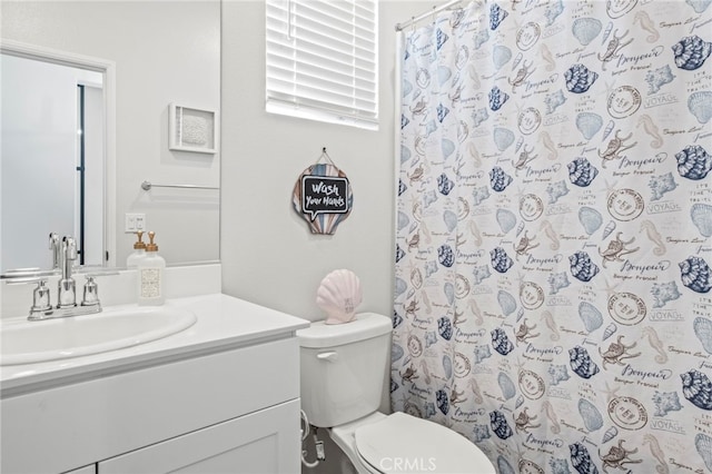 bathroom featuring walk in shower, vanity, and toilet