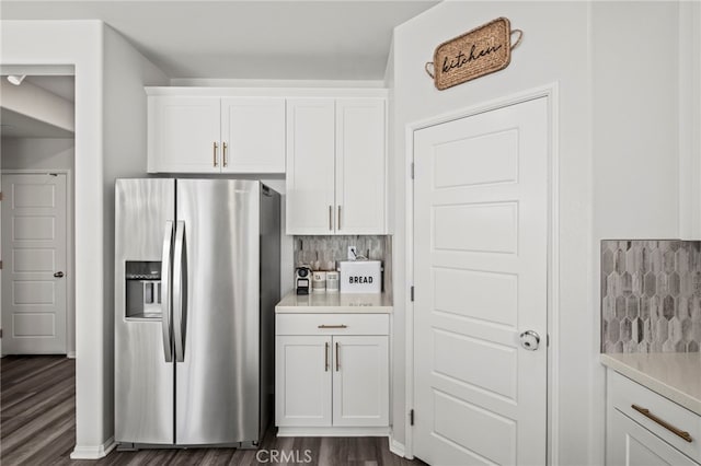 kitchen with white cabinetry, stainless steel fridge with ice dispenser, and decorative backsplash