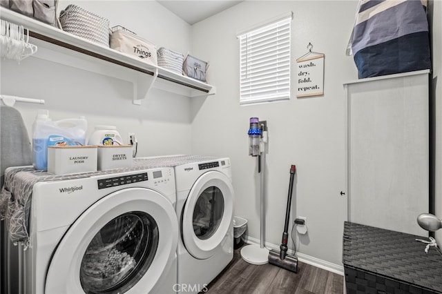 laundry room with dark wood-type flooring and washer and dryer