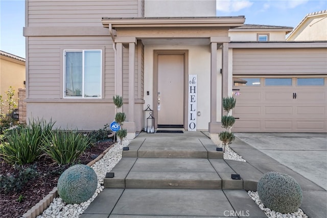 view of exterior entry with a garage