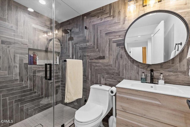 bathroom featuring tile walls, backsplash, vanity, toilet, and a shower with door